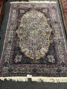 A fringed Persian Kirman carpet with tree of life design,