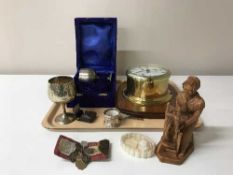 A circular brass ships clock mounted on board, a pair of cased goblets,