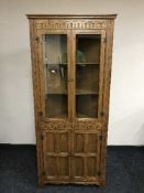 An oak leaded door corner cabinet