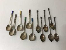 A set of six sterling silver and enamelled teaspoons and six plated twist teaspoons