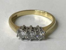 An 18ct gold three stone diamond ring