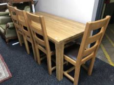 A light oak dining table and four chairs