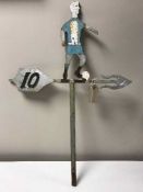 A cast metal weather vane in the form of a footballer