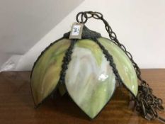 A decorative metal light fitting with opaque glass panels