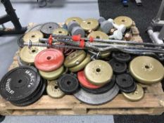 A pallet of assorted weight lifting weights and bars