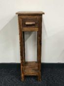 A hardwood plant stand fitted a drawer