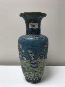 A large cloisonne vase depicting storks in flight