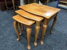 A nest of three colonial style tables