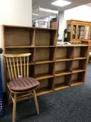 A large set of teak open shelves and an Ercol dining chair