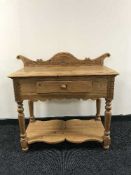 A carved pine hall table fitted a drawer