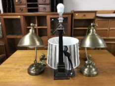 A pair of contemporary brass finished desk tamps together with a table lamp with shade
