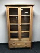 A glazed door bookcase fitted two drawers