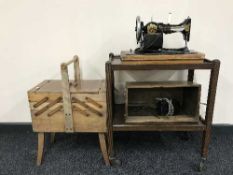 A cased Jones sewing machine, walnut dining table,