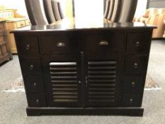 A multi drawer side cabinet with double cupboard base