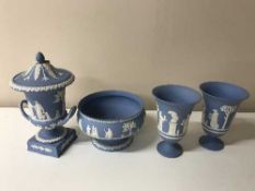 A tray containing four pieces of Wedgwood blue and white jasperware including a pair of vases