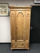 A Victorian style pine wardrobe fitted a drawer