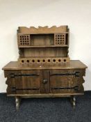 A pine double door sideboard with metal fittings and a pine wall rack