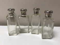 A set of four silver topped bottles
