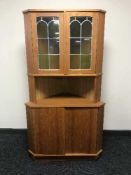 A teak corner display cabinet