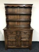 A carved oak kitchen dresser