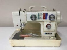 A cased Newhome electric sewing machine