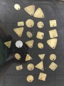 Twenty six miner's lamp checks (tokens or tallies) in a glass display case