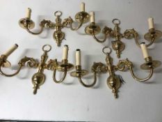 Four brass two-way wall lights