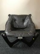 A contemporary button leather sling chair