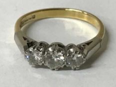 An 18ct gold three stone diamond ring
