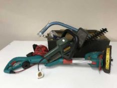 A box containing Bosch strimmer, Black and Decker electric hedge trimmer,