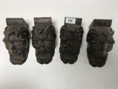 A set of four carved oak corbels
