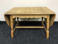 A blonde oak flap sided coffee table