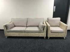 A wicker framed settee and matching armchair