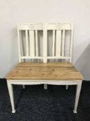 A painted bench with a reclaimed pine seat