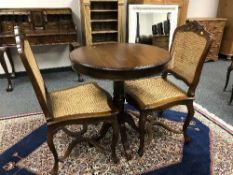 A Victorian style pedestal table and a pair of bergere dining chairs (3)