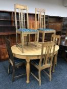 An early 20th century oval oak extending table and six chairs