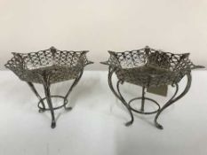 A pair of sterling silver pierced rimmed dishes on stands, bearing London hallmarks, dated 1925,