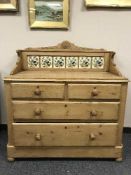 A Victorian pine tiled back four drawer chest