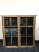 An Edwardian oak bookcase and set of children's encyclopedia
