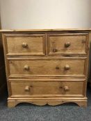 A pine four drawer chest