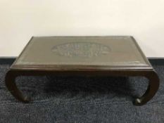 A carved oriental style coffee table