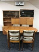 A late 20th century teak extending dining table and four chairs.