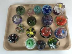 A tray of seventeen assorted glass paperweights