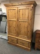 A pine double door wardrobe fitted two drawers