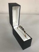 A 9ct gold sapphire and diamond bangle in box