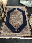 A fringed Persian Tabriz rug with central medallion on blue ground,