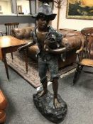 An impressive bronze fountain statue of a boy fishing