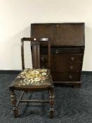 An oak bureau and a dining chair