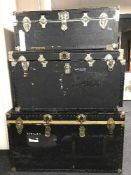 Three graduated luggage trunks
