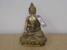A brass figure of a Buddha